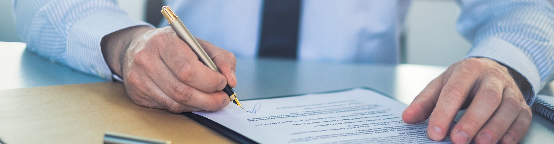 Business man signing contract, making a deal. professional-liability-banner